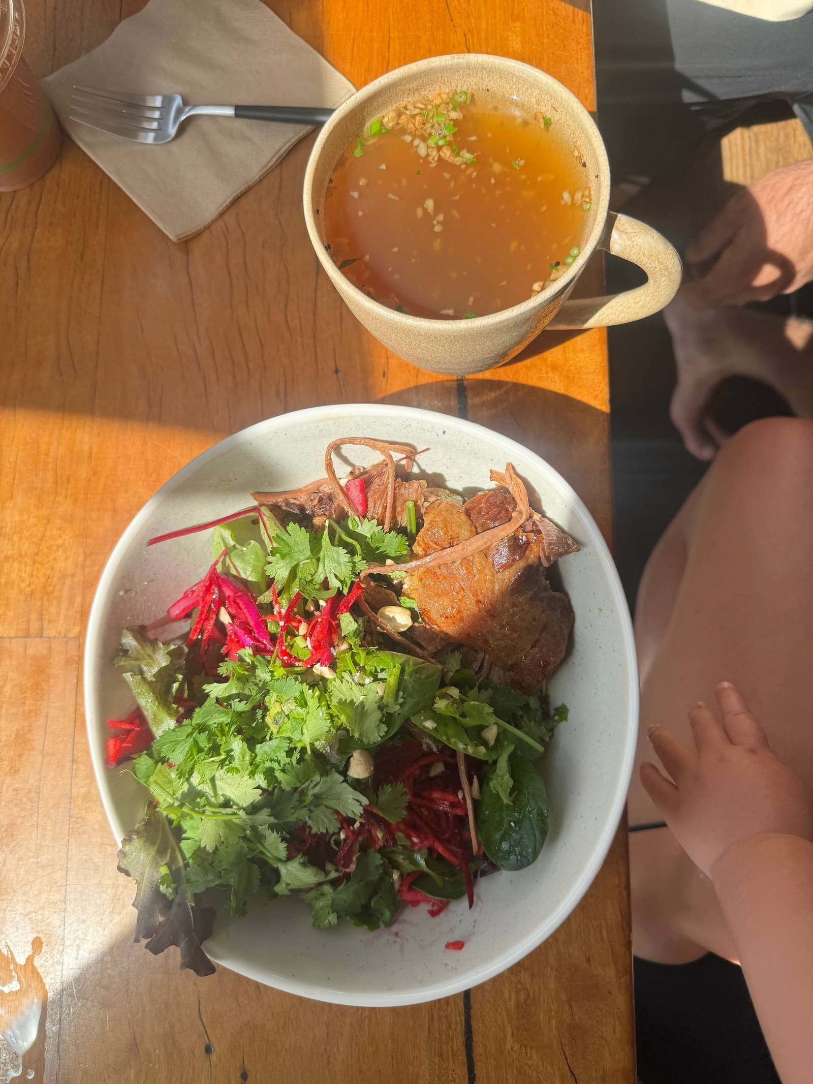 A wholefoods meal out - slow-cooked meat with a fresh herb and beetroot salad and a cup of broth
