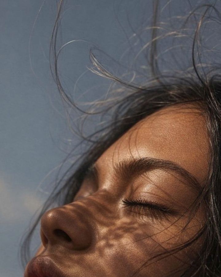 Woman's face in dappled light.