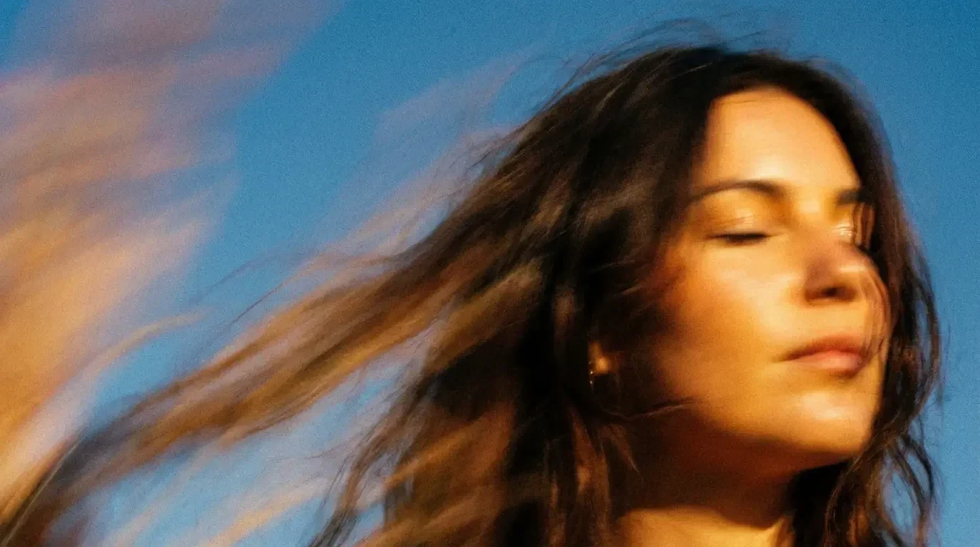 Warm portrait — soft amber light across face and hair