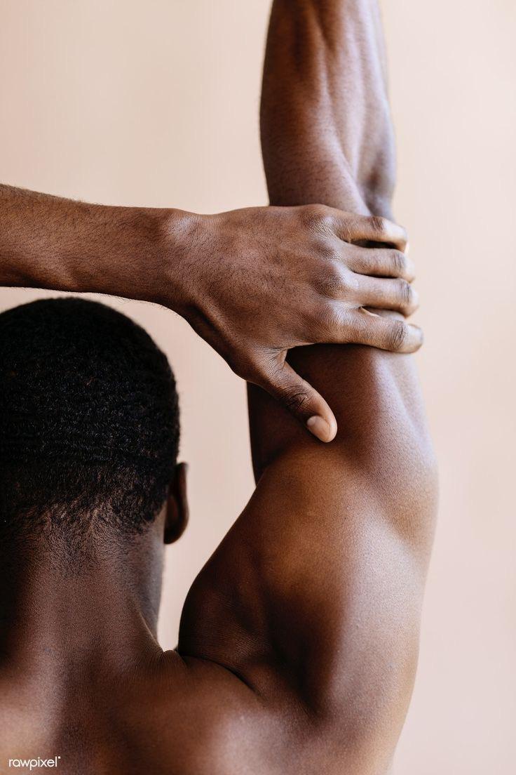Close crop of a man's shoulder and arm mid stretch.